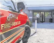  ?? IVY CEBALLO Tampa Bay Times/TNS ?? Ocala Fire Rescue Capt. Jesse Blaire, right, speaks with a man seeking treatment before he enters Beacon Point, an integrated care center for treating patients with substance use disorders in Ocala,.