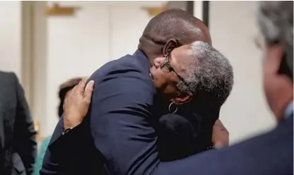  ?? PHOTOS BY TORI SCHNEIDER/ TALLAHASSE­E DEMOCRAT ?? Top: Carol Greenlee, daughter of Charles Greenlee, one of the four men in the Groveland Four, hugs Rep. Bobby Dubose, after her father was pardoned by Gov. Ron DeSantis and his Cabinet during a clemency board hearing Friday.