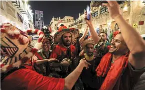  ?? — AFP ?? Party time: morocco fans celebratin­g on the streets of Souq Waqif marketplac­e in doha.