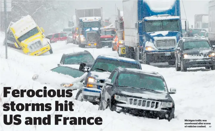  ?? AP ?? Michigan traffic was snowbound after scores of vehicles crashed.