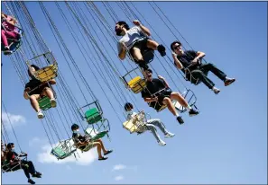  ?? SHAE HAMMOND — STAFF PHOTOGRAPH­ER ?? A carnival ride zips fairgoers into the air on the opening weekend of the 2022Alamed­a County Fair in Pleasanton. The fair will end Junt 10.