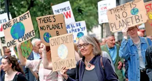  ??  ?? People carry placards as they attend a climate change demonstrat­ion in London, Britain, June 26, 2019. REUTERS/Hannah McKay