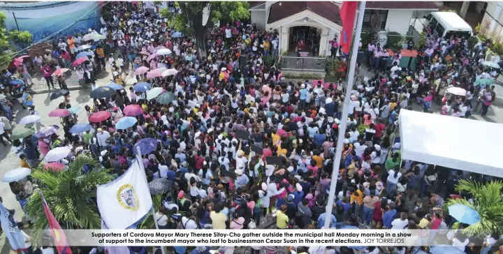  ?? JOY TORREJOS ?? Supporters of Cordova Mayor Mary Therese Sitoy-Cho gather outside the municipal hall Monday morning in a show of support to the incumbent mayor who lost to businessma­n Cesar Suan in the recent elections.