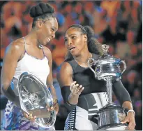  ?? Picture: REUTERS ?? SISTER ACT: Serena Williams of the US talks while holding her trophy after winning the Autralian Open women’s singles final match against her sister Venus Williams