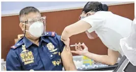  ??  ?? DIRECTOR of PNP Health Service Luisito Magnaye is among the first ones vaccinated at the PNP Multipurpo­se Center, Camp Crame.