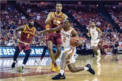  ?? Lola Gomez/Austin American-Statesman via AP ?? ■ Texas' Matt Coleman III (2) moves the ball as Iowa State's Tyrese Haliburton (22) defends during an NCAA college basketball game Saturday in Austin.