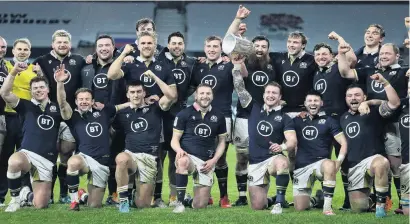  ?? PHOTO: GETTY IMAGES ?? Scotland the brave . . . Scotland captain Stuart Hogg holds the Calcutta Cup aloft as his team celebrate victory over England at Twickenham yesterday. Scotland won 116.