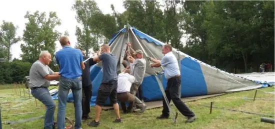  ?? FOTO JOHNNY GEURTS ?? Met man en macht wordt de enorme spantent rechtgezet voor de vierdaagse kermis.