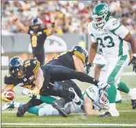  ?? CP PHOTO ?? Hamilton Tiger-Cats’ John White IV, left, scores a touchdown past Saskatchew­an Roughrider­s’ Jerome Messam, right, during first half CFL football action in Hamilton, Ont., on July 19.