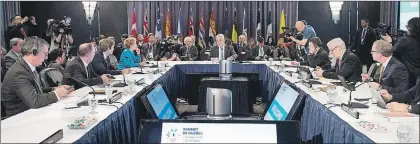  ??  ?? Quebec Premier Philippe Couillard (centre) speaks at the beginning of a summit on climate change provincial premiers and territoria­l leaders look on, Tuesday in Quebec City.