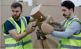  ??  ?? Thinking outside the box … puppeteers act out Robox, star of Amazon warehouse play Fulfilment. Photograph: Tom Ziebell