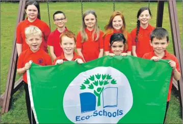  ?? 15_t45dunbeg0­1 ?? Dunbeg Pirmary School’s eco committee proudly show off the school’s sixth green flag.