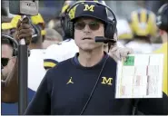  ?? ASSOCIATED PRESS FILE PHOTO ?? Coach Jim Harbaugh and Michigan were forced to cancel Saturday’s game against Maryland due to the Wolverines’ current COVID-19 outbreak. Ohio State is next on Dec. 12.