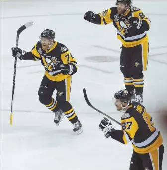  ?? AP PHOTO ?? ALL PITTSBURGH: Patric Hornqvist (72), Phil Kessel (81) and Sidney Crosby celebrate a goal during last night’s Game 5 of the Stanley Cup finals against the Predators. The Penguins rolled to a 6-0 victory to take a 3-2 lead in the series.
