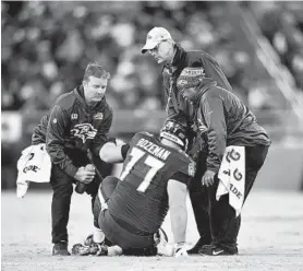  ?? GAIL BURTON/ASSOCIATED PRESS ?? The Ravens’ Bradley Bozeman is helped to his feet during a game against the Saints. Bozeman made his first career start Sunday, replacing the injured Alex Lewis.