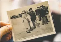  ?? (Lancaster LNP/Ty Lohr) ?? Adams holds a photo of Queen Elizabeth II (left) at his home. Adams was stationed at a base in England, shooting photograph­s of notables and royalty. He photograph­ed Elizabeth, the Queen Mother, one afternoon as she inspected the base with her then-teenaged daughter, the future Queen Elizabeth II.