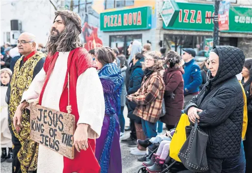  ?? NICK LACHANCE TORONTO STAR ?? People march in honour of Good Friday in Toronto’s Little Italy. The procession, which was first held in 1962, started at St. Francis of Assisi Parish at the corner of Grace Street and Mansfield Avenue. The church says on its website that the procession “is a way of celebratin­g not only our faith, but also our heritage.”