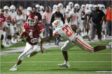  ?? Staff photo by Evan Lewis ?? n Arkansas High quarterbac­k Drake Browning is finally brought down by Texas High's Kendrick Reeves in the final seconds of the first quarter in Friday night's crosstown rivalry matchup. Browning's run set up a Razorback touchdown. The Hogs beat the...