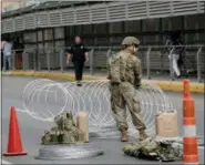  ?? ERIC GAY — THE ASSOCIATED PRESS ?? Members of the U.S.military place razor wire along the U.S.-Mexico border on the McAllen-Hidalgo Internatio­nal Bridge, Friday in McAllen, Texas.