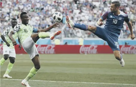  ??  ?? Nigeria midfielder John Obi Mikel (right) battles against Iceland’s Gylfi Sigurdsson yesterday. Nigeria won the Group D match 2-0.