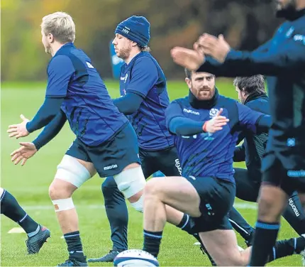  ?? Pictures: SNS. ?? John Barclay, top left, pictured at training yesterday; Gregor Townsend in talks with his backroom team.
