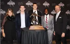  ?? (NWA Democrat-Gazette/Carin Schoppmeye­r) ?? Vickie Burlsworth (from left), Stetson Bennett IV, Aidan O’Connell, Carlton Martial and Marty Burlsworth stand for a photo with the Brandon Burlsworth Trophy for which Bennett, O’Connell and Martial were finalists.