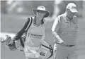  ?? BEACON JOURNAL ?? Brenda Calcavecch­ia, left, caddies for husband Mark Calcavecch­ia in the 2020 Bridgeston­e Senior Players Championsh­ip.