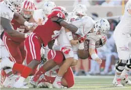  ?? ANDY LYONS/GETTY IMAGES ?? Maryland quarterbac­k Perry Hills is sacked in Saturday’s game. The Terps lost to Indiana, 42-36, partly because of turnovers by Hills.