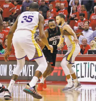  ?? Carlos Avila Gonzalez / The Chronicle ?? Houston’s James Harden tries to drive between defenders Kevin Durant and Stephen Curry. Harden scored 41 points and had seven assists in his team’s Game 1 loss on Monday night.