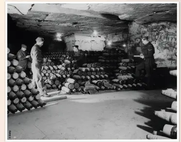  ??  ?? Soldiers check the issue of six-inch shells in one of the huge bays of the RAOC’S undergroun­d arsenal, May 1944