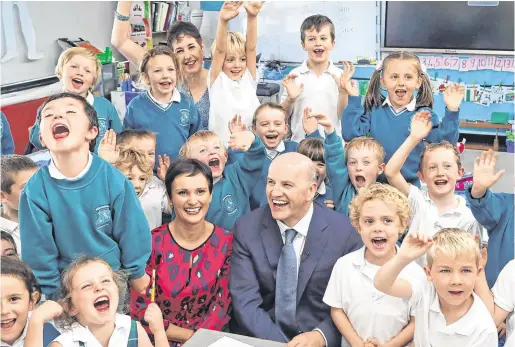  ?? PHOTO: COLIN KEEGAN ?? Class act: Presidenti­al candidate Seán Gallagher at St Laurence’s Primary School, Co Wicklow, with his wife Trish and their son Bobby (5), and other pupils from Bobby’s class.