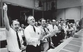  ?? NASA ?? The four Apollo 13 flight crew directors who brought the crippled spacecraft back to Earth celebrate at their post in Mission Control as they learn of the command module’s successful splashdown on April 17, 1970. From left are Gerald Griffin, Eugene...