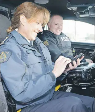  ?? HEATHER TAWEEL/THE GUARDIAN ?? When Chief Superinten­dent Joanne Crampton, commanding officer of the RCMP in P.E.I., wanted to learn the social media ropes she turned to the master, Const. Jamie Parsons. They not only patrolled together on Monday morning, both were engaging the...