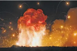  ?? Efrem Lukatsky / Associated Press ?? A powerful explosion — believed by Ukrainian intelligen­ce to be sabotage — struck an ammunition depot Wednesday on a military base in Kalynivka, Ukraine.