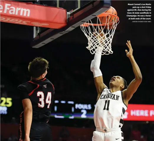  ?? KIRSTEN STICKNEY/SUN-TIMES ?? Mount Carmel’s Lee Marks puts up a shot Friday against Mt. Zion during the Class 3A state semifinals in Champaign. He was a factor at both ends of the court.