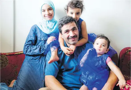  ?? PHOTOS: ASHLEY FRASER ?? Wael Aun with his daughters, from left, 11-year-old Khadijah, four-year-old Mariam and 15-month old Hanna. Wael is among the first Syrian refugees to open his own business, a furniture upholstery operation.