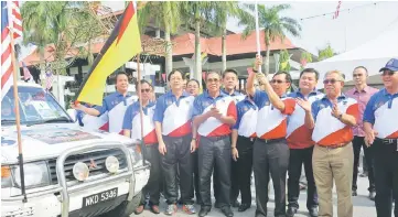  ??  ?? Dr Rundi (fourth right) flags off the ‘Jalur Gemilang’ convoy.