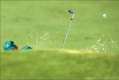  ?? BRIAN SNYDER / REUTERS ?? The sand flies as a golfer negotiates a bunker during the US Masters in Georgia, on Sunday.