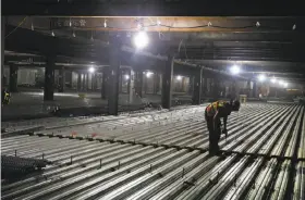  ?? Paul Chinn / The Chronicle ?? A constructi­on worker works on a garage level of the California Pacific Medical Center hospital building project on Van Ness Avenue.