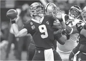  ??  ?? Saints quarterbac­k Drew Brees overcame a game-opening, first-drive intercepti­on to throw for 301 yards and two TDs.