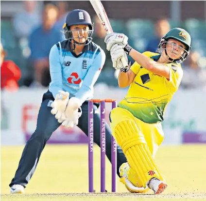  ??  ?? Making her mark: Beth Mooney hits out during her innings of 25 for Australia as England’s Sarah Taylor looks on