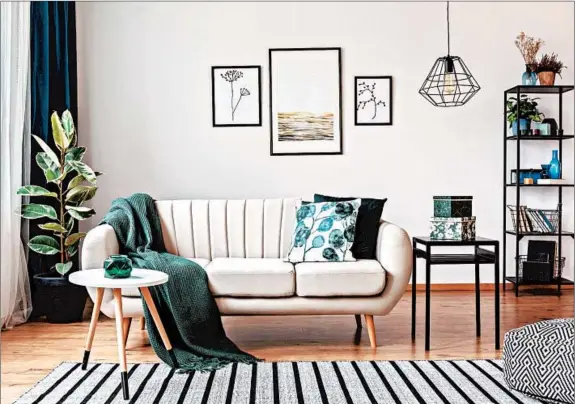  ?? GETTY ?? Limit yourself to one or two colors and patterns and repeat them throughout, using accessorie­s such as pillows or vases to tie the room together.