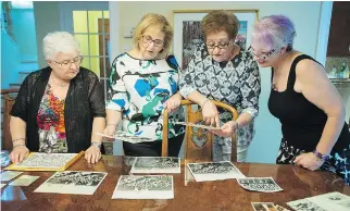  ??  ?? Teresa Barletta, left, Maria Venditti Germani, Ida Teolis Venafro and Clotilde Leone Keklikian look at old photograph­s at Anna Di Turi’s T.M.R. home. “Reconnecti­ng with these ladies gives me support,” says Venditti Germani.