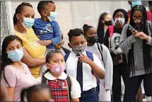  ?? JOHN MINCHILLO / AP ?? In this Sept. 9, 2020, file photo, students wear protective masks as they arrive for classes at the Immaculate Conception School while observing COVID-19 prevention protocols in The Bronx borough of New York.