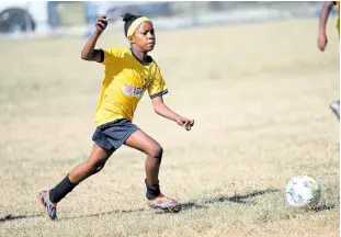  ?? RICARDO MAKYN/CHIEF PHOTO EDITOR ?? Norbrook Strikers’ lone female goes on a dribble during one of the Youth Football League’s Junior Cup all-island games at the University of the West Indies’ Mona Bowl yesterday.