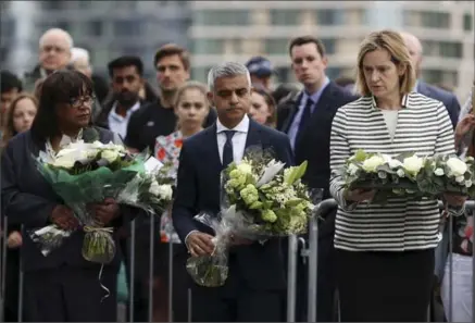  ?? DAN KITWOOD, GETTY IMAGES ?? Shadow Home Secretary Diane Abbott, left, London Mayor Sadiq Khan, centre, and Home Secretary Amber Rudd take part in a vigil for the victims of the London Bridge terror attacks in Potters Fields Park in London on Monday.
