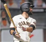  ??  ?? The Giants’ Brandon Belt watches his tworun homer fly to center field.