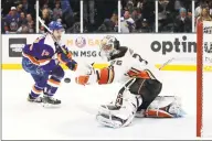  ?? Jim McIsaac / Associated Press ?? Anaheim Ducks goaltender John Gibson (36) stops a breakaway chance from New York Islanders center Mathew Barzal on Saturday.