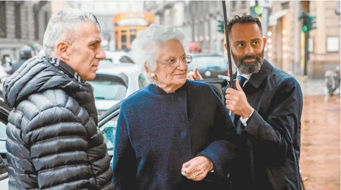 ??  ?? Holocaust survivor and Italian senator for life Liliana Segre (centre), accompanie­d by bodyguards in Milan.