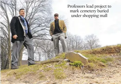 ?? LLOYD FOX/BALTIMORE SUN PHOTOS ?? Ron Castanzo, left, a professor at the University of Baltimore, and Elgin Klugh, a professor at Coppin State University, are working to excavate and memorializ­e Laurel Cemetery, now buried beneath a strip mall on Belair Road. Some headstones are still visible.